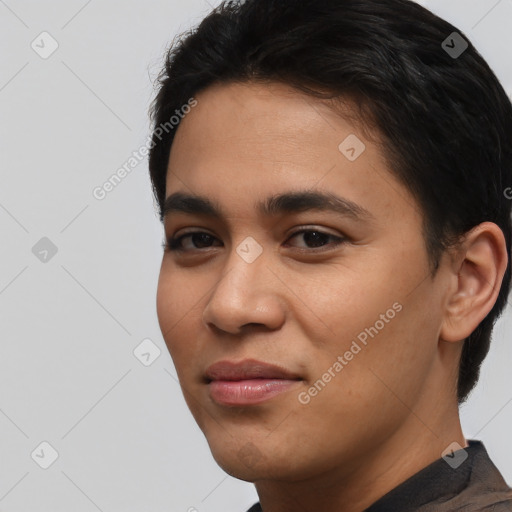 Joyful latino young-adult male with short  black hair and brown eyes