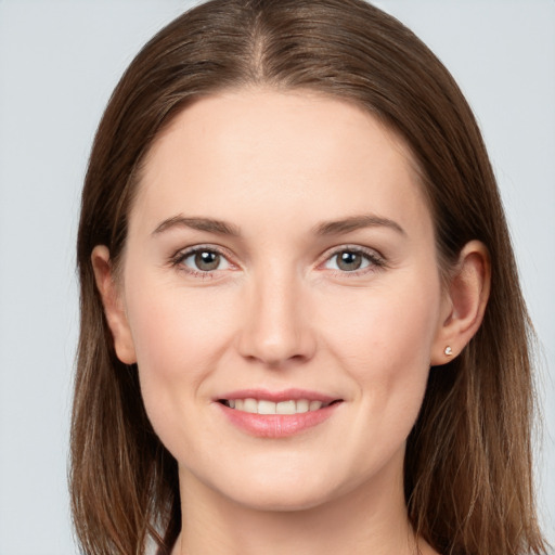 Joyful white young-adult female with long  brown hair and grey eyes