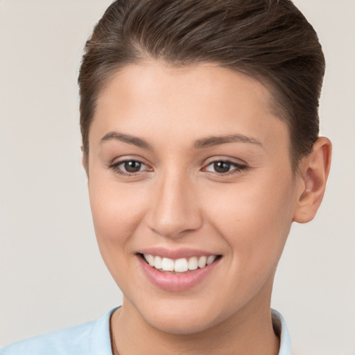 Joyful white young-adult female with short  brown hair and brown eyes