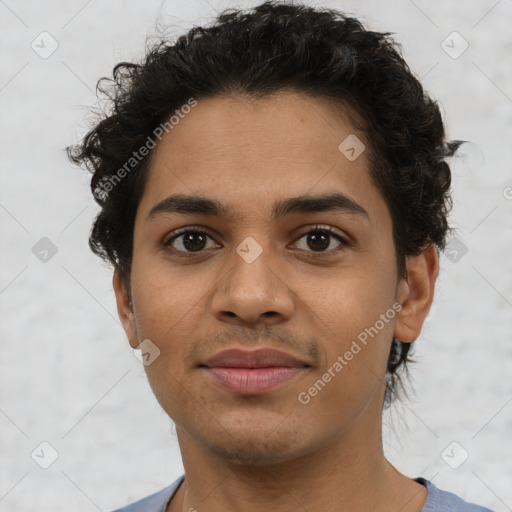 Joyful latino young-adult male with short  brown hair and brown eyes