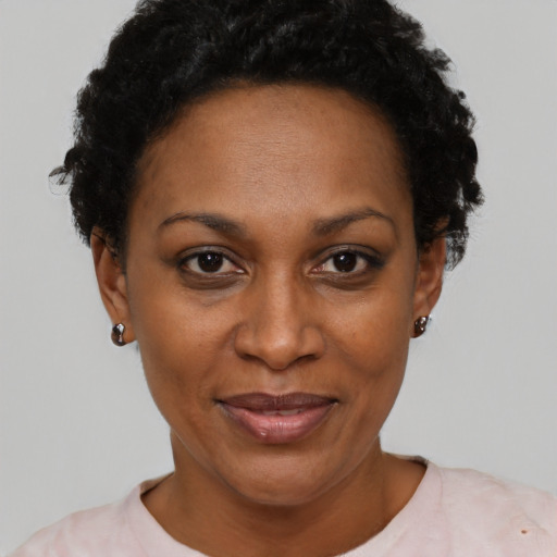 Joyful black adult female with short  black hair and brown eyes