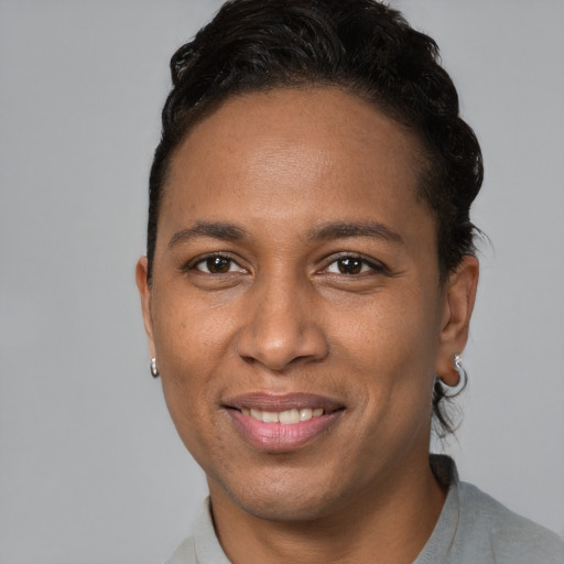 Joyful black young-adult male with short  brown hair and brown eyes