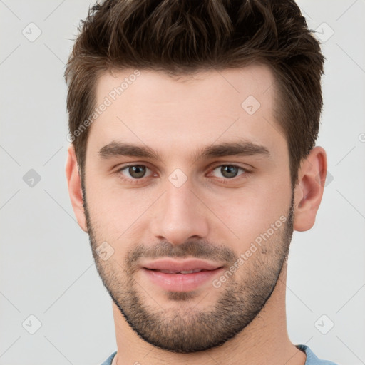 Joyful white young-adult male with short  brown hair and brown eyes