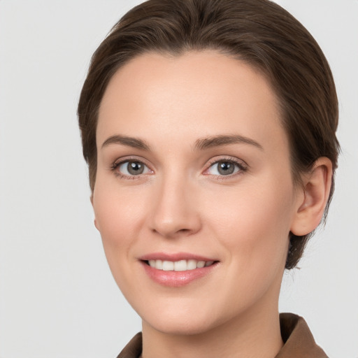 Joyful white young-adult female with short  brown hair and grey eyes