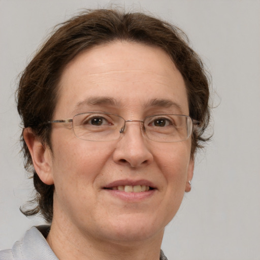 Joyful white adult female with short  brown hair and grey eyes