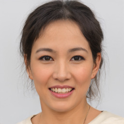 Joyful asian young-adult female with short  brown hair and brown eyes