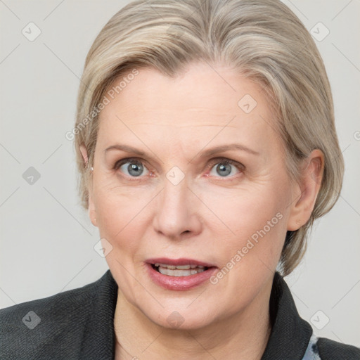 Joyful white adult female with medium  brown hair and blue eyes