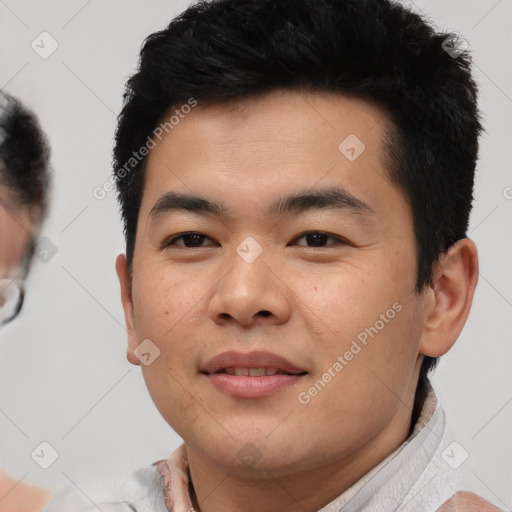 Joyful asian young-adult male with short  brown hair and brown eyes