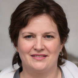 Joyful white adult female with medium  brown hair and grey eyes