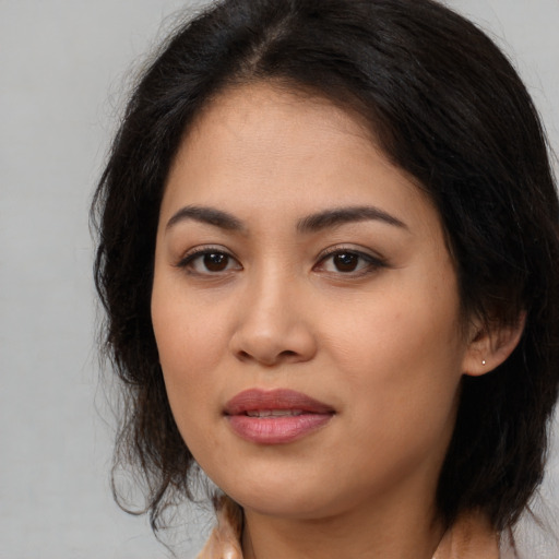 Joyful asian young-adult female with medium  brown hair and brown eyes