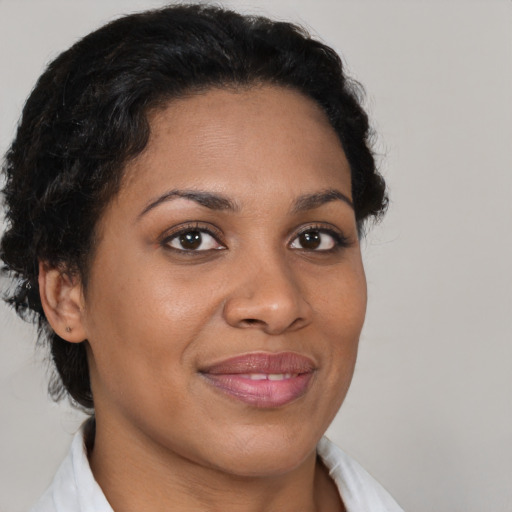 Joyful black young-adult female with short  brown hair and brown eyes