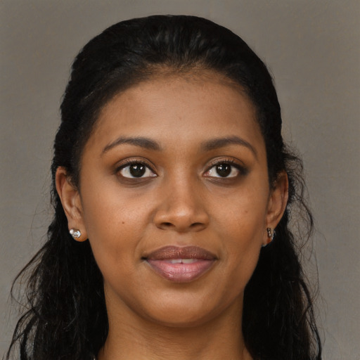 Joyful black young-adult female with long  black hair and brown eyes