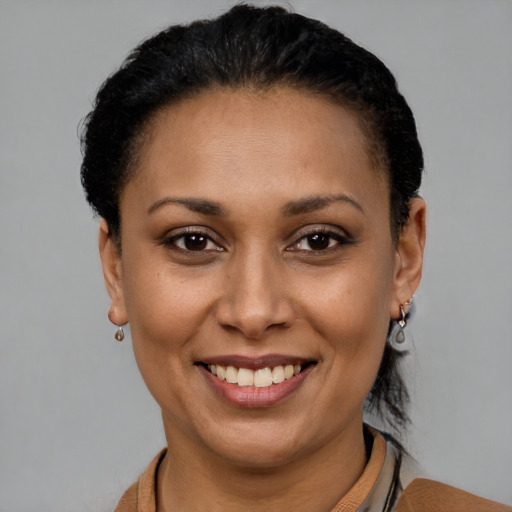 Joyful latino adult female with short  brown hair and brown eyes