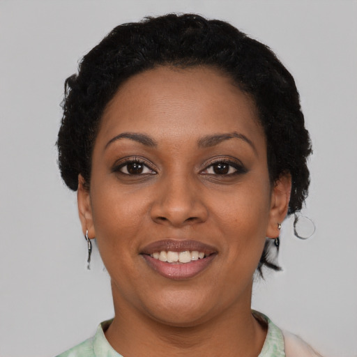 Joyful latino young-adult female with short  black hair and brown eyes