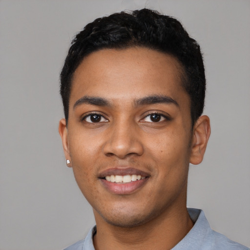 Joyful black young-adult male with short  black hair and brown eyes