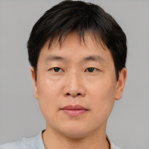 Neutral asian adult male with short  brown hair and brown eyes