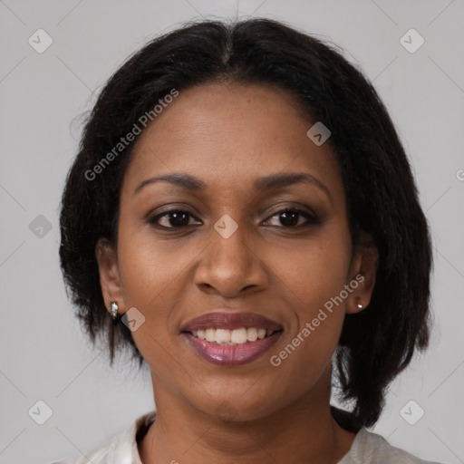 Joyful black adult female with medium  brown hair and brown eyes