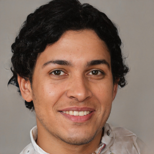 Joyful latino young-adult male with short  brown hair and brown eyes