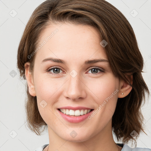 Joyful white young-adult female with medium  brown hair and green eyes