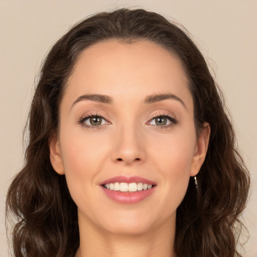 Joyful white young-adult female with long  brown hair and brown eyes