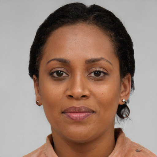 Joyful black young-adult female with short  brown hair and brown eyes