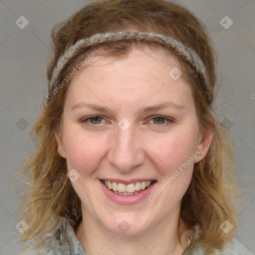 Joyful white young-adult female with medium  brown hair and blue eyes