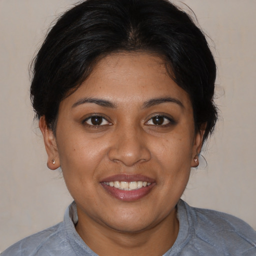 Joyful black young-adult female with medium  brown hair and brown eyes