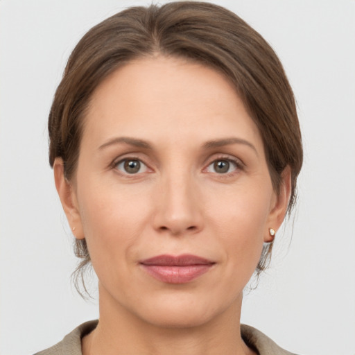 Joyful white adult female with short  brown hair and grey eyes