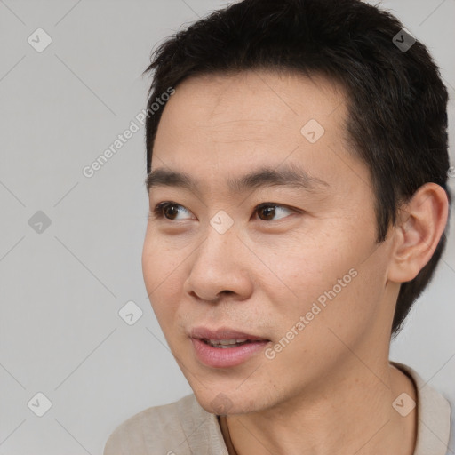 Joyful white young-adult male with short  black hair and brown eyes
