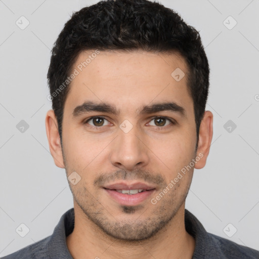 Joyful white young-adult male with short  black hair and brown eyes