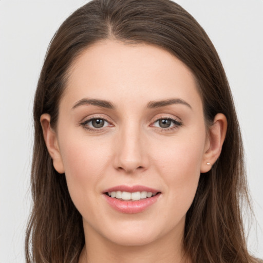 Joyful white young-adult female with long  brown hair and grey eyes