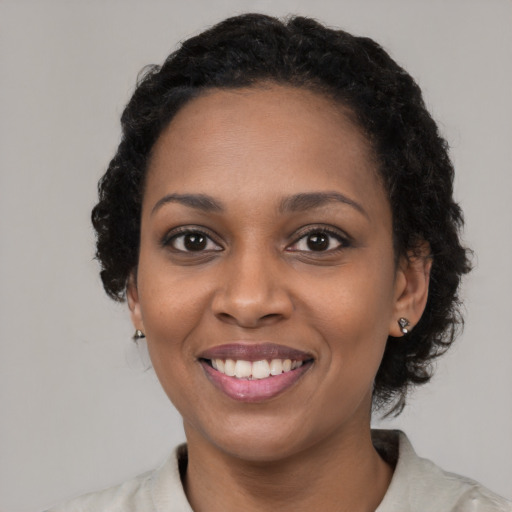 Joyful latino young-adult female with medium  black hair and brown eyes