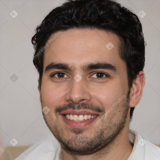 Joyful white young-adult male with short  black hair and brown eyes