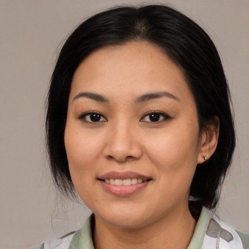 Joyful latino young-adult female with medium  black hair and brown eyes
