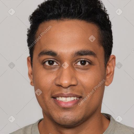 Joyful black young-adult male with short  black hair and brown eyes