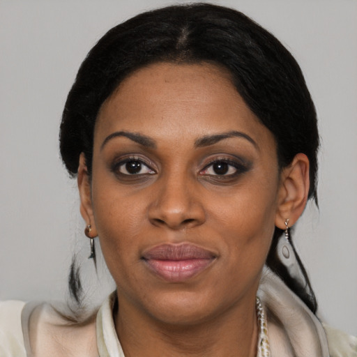 Joyful black young-adult female with medium  brown hair and brown eyes