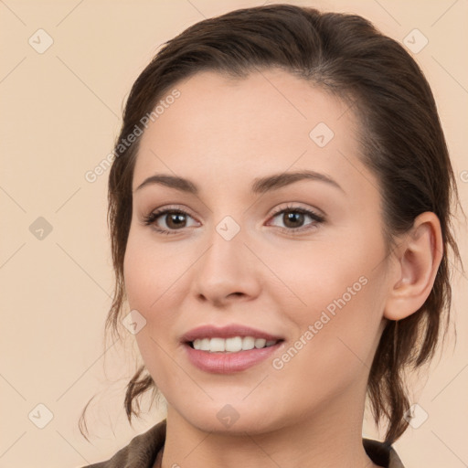 Joyful white young-adult female with long  brown hair and brown eyes