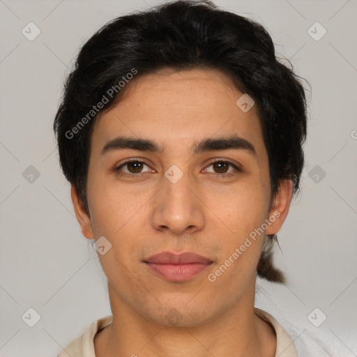 Joyful latino young-adult male with short  brown hair and brown eyes