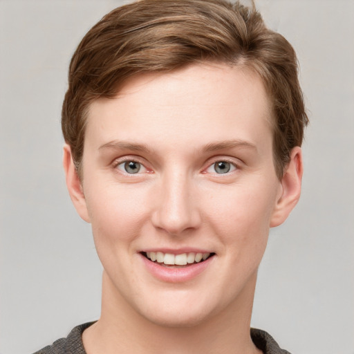 Joyful white young-adult female with short  brown hair and grey eyes