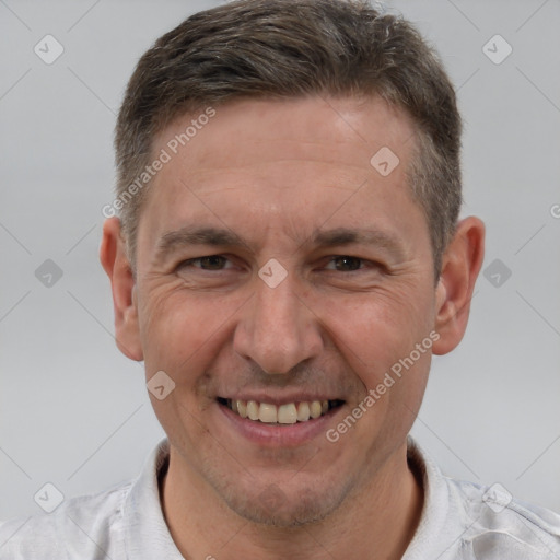 Joyful white adult male with short  brown hair and brown eyes