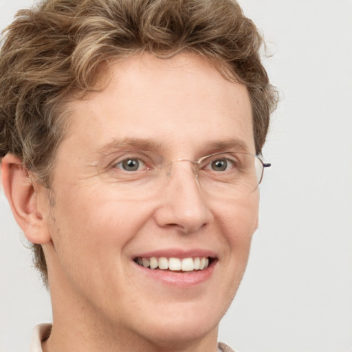 Joyful white adult male with short  brown hair and grey eyes