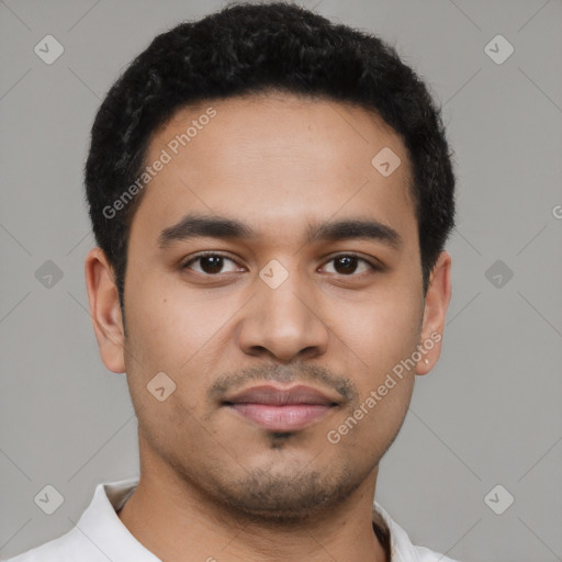 Joyful latino young-adult male with short  black hair and brown eyes