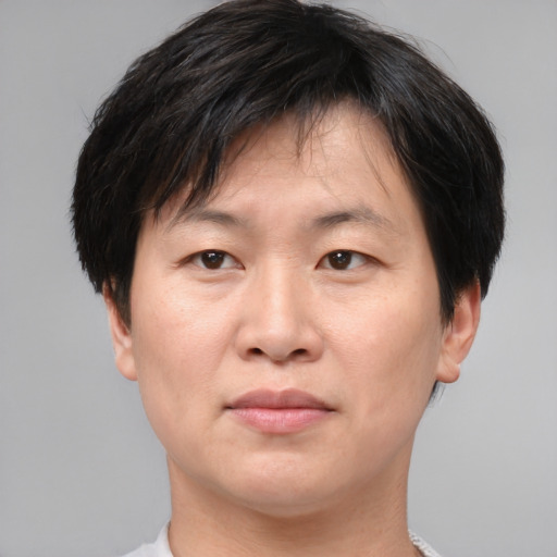 Neutral asian adult male with short  brown hair and brown eyes