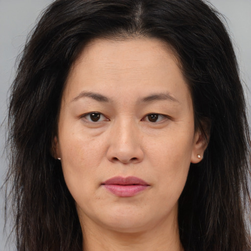 Joyful white adult female with long  brown hair and brown eyes