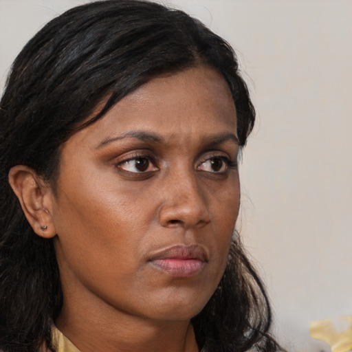 Neutral black young-adult female with medium  brown hair and brown eyes