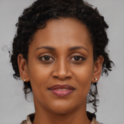 Joyful black young-adult female with medium  brown hair and brown eyes