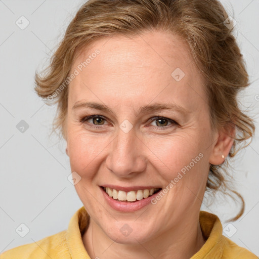 Joyful white adult female with medium  brown hair and blue eyes