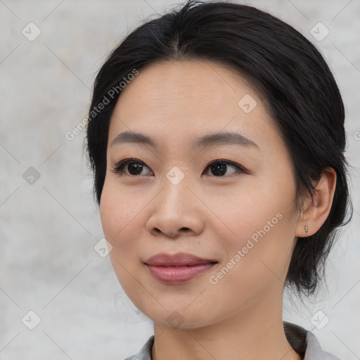 Joyful asian young-adult female with medium  black hair and brown eyes