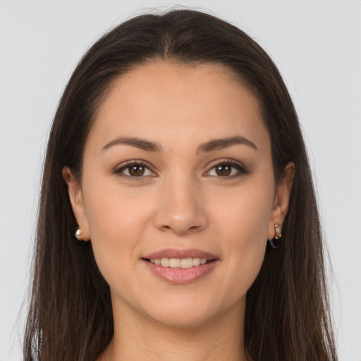 Joyful white young-adult female with long  brown hair and brown eyes