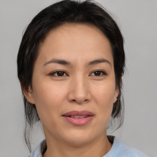 Joyful asian young-adult female with medium  brown hair and brown eyes